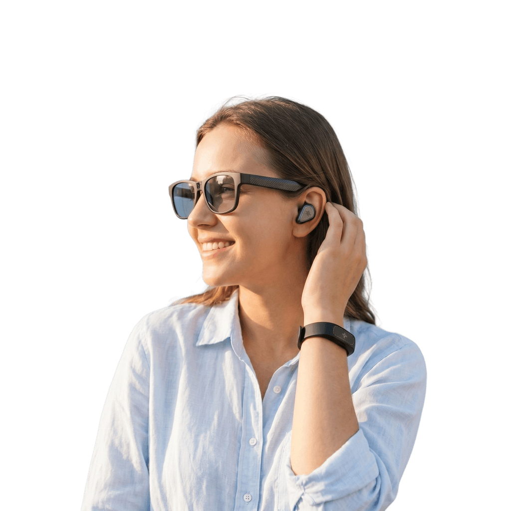 Smiling woman wearing Luminexis smart eyewear and hearing assist